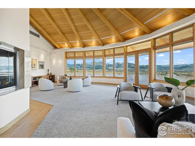 a living room with furniture and a floor to ceiling window