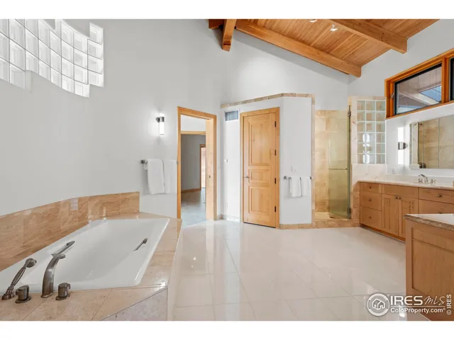 a bathroom with a tub sink and mirror