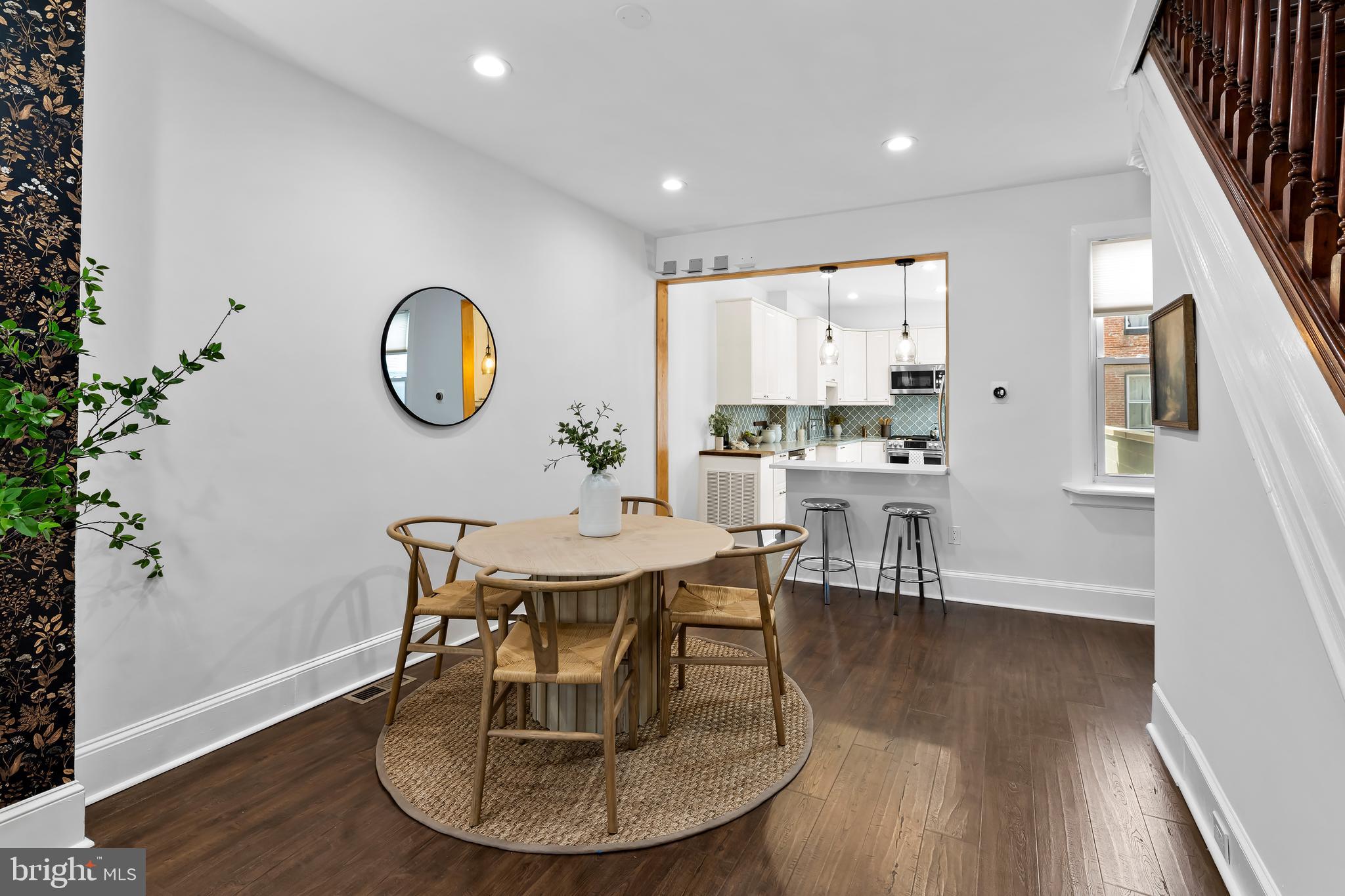 2529 Eastern Avenue Baltimore, MD 21224 - Photo 11 of 50 an open kitchen with wooden floor and a chair