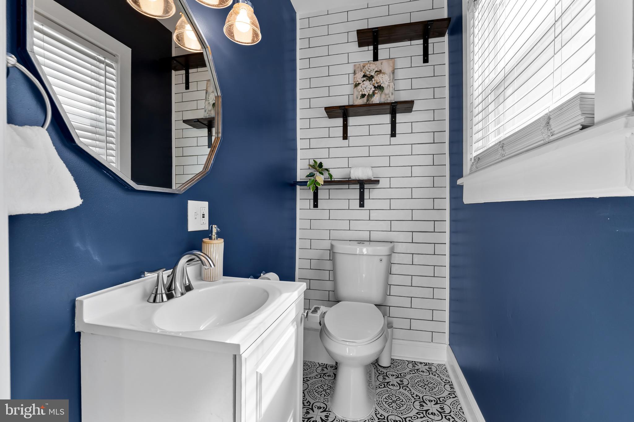 2529 Eastern Avenue Baltimore, MD 21224 - Photo 17 of 50 a bathroom with a toilet a sink and mirror