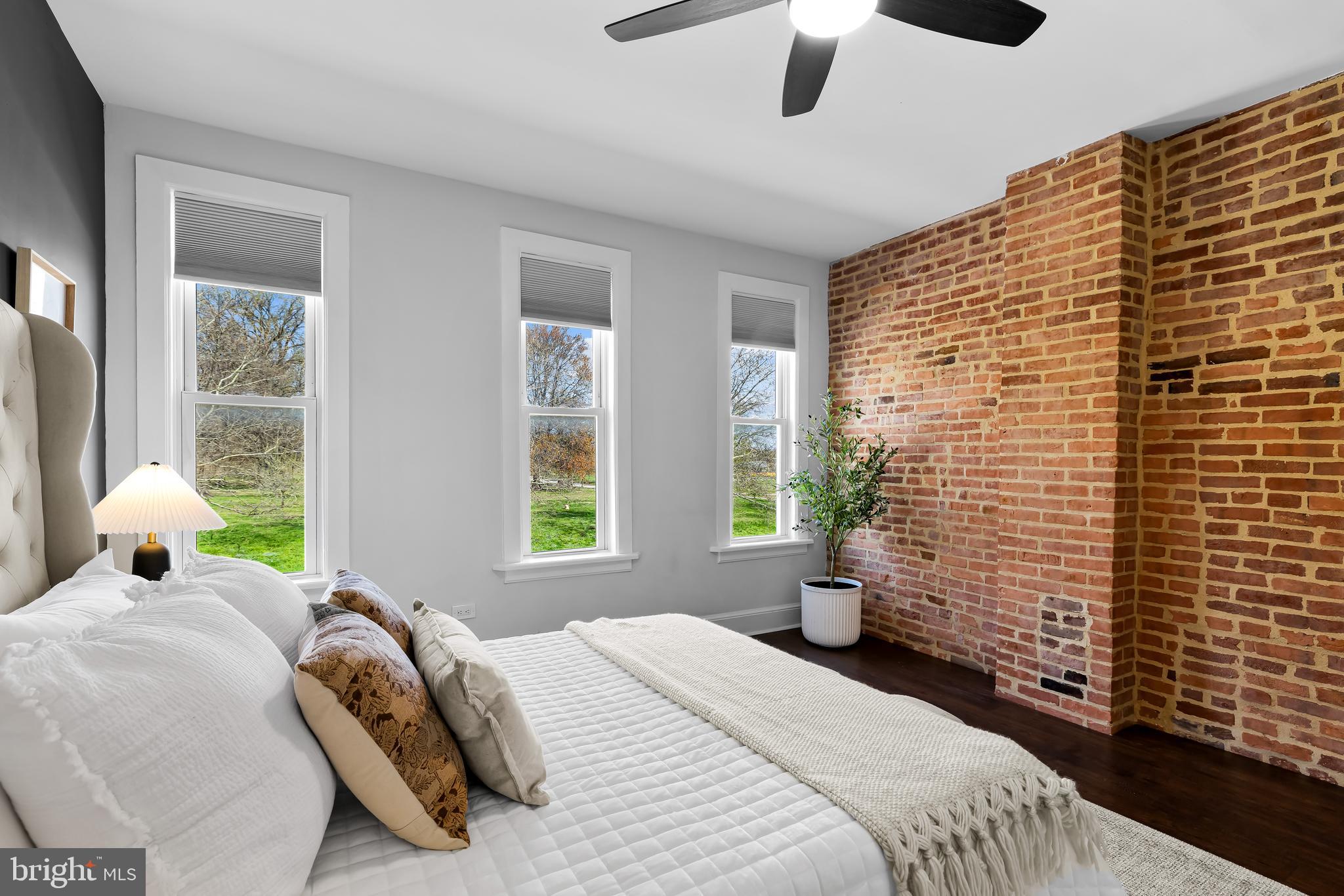 2529 Eastern Avenue Baltimore, MD 21224 - Photo 22 of 50 a bedroom with a bed and a chandelier