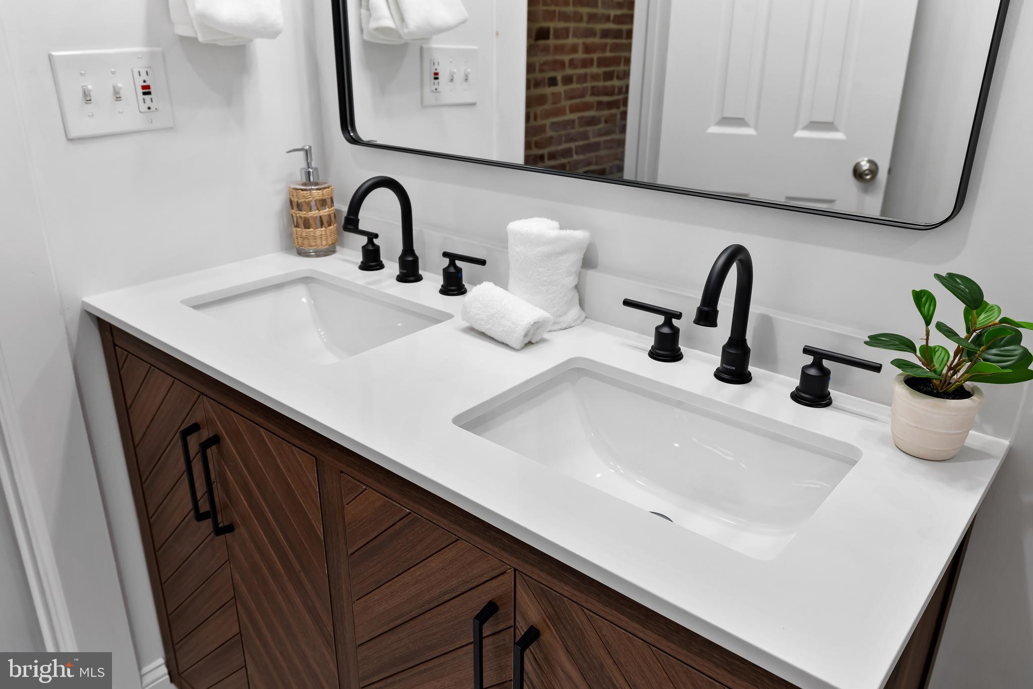 2529 Eastern Avenue Baltimore, MD 21224 - Photo 26 of 50 a bathroom with a sink and a mirror
