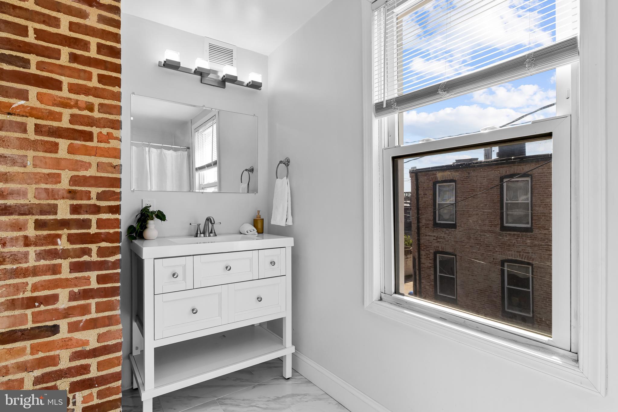 2529 Eastern Avenue Baltimore, MD 21224 - Photo 29 of 50 a bathroom with a double vanity sink mirror and