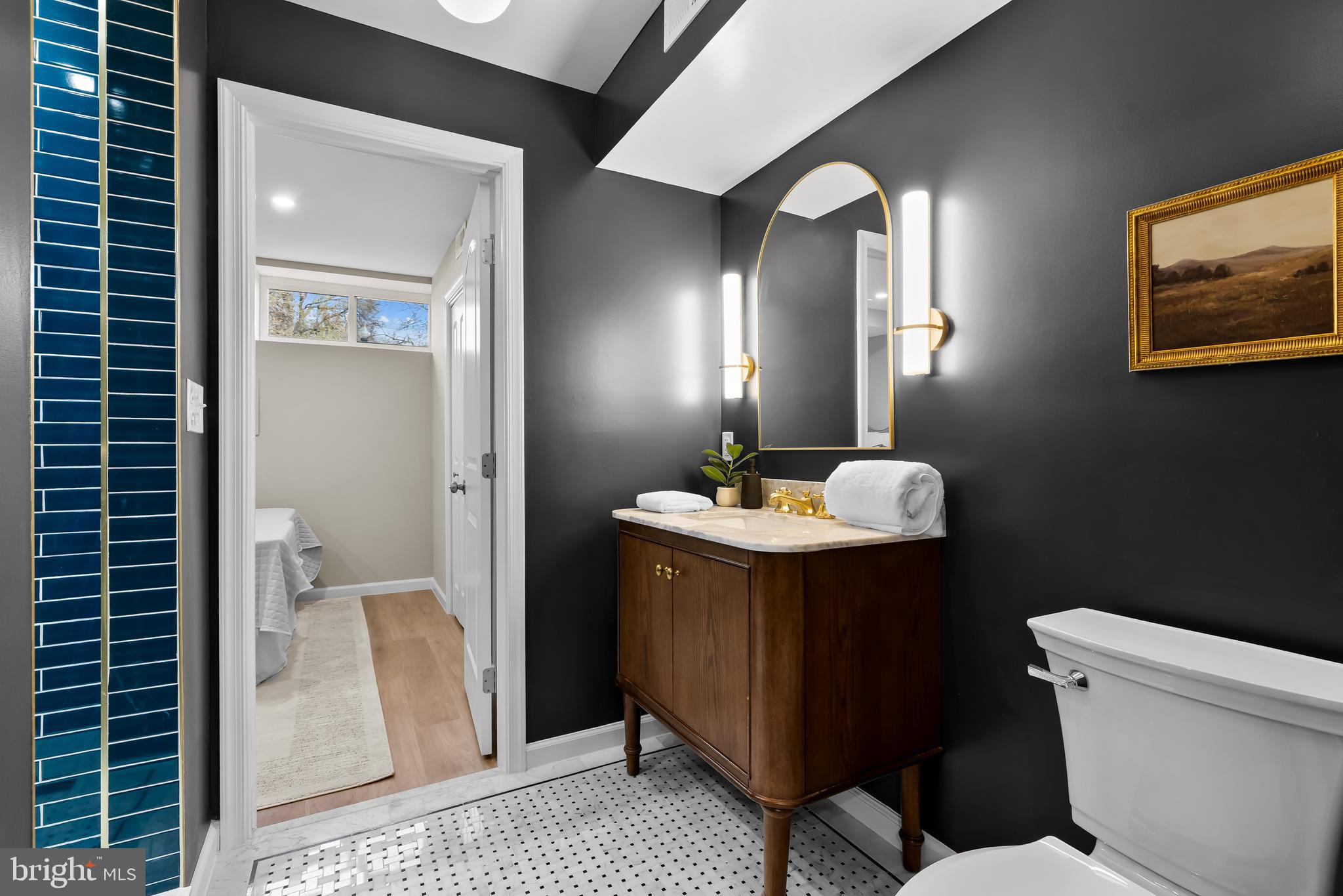 2529 Eastern Avenue Baltimore, MD 21224 - Photo 33 of 50 a bathroom with a toilet sink and mirror