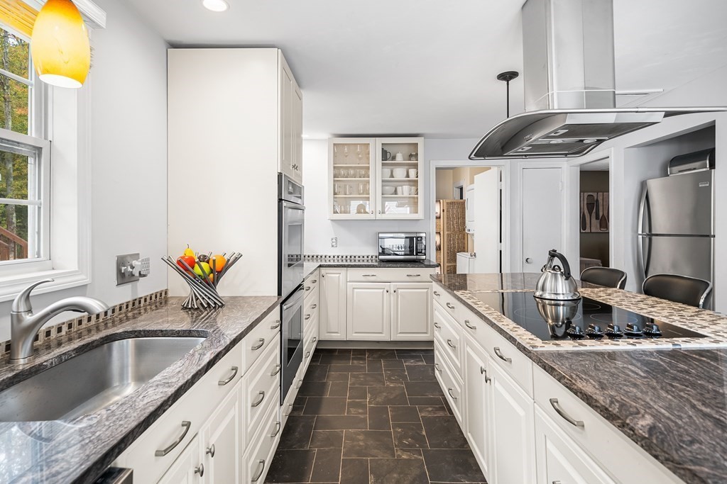 9 Tucker Lane Sutton, MA 01590 - Photo 11 of 33 a kitchen with stainless steel appliances granite countertop a sink stove and cabinets