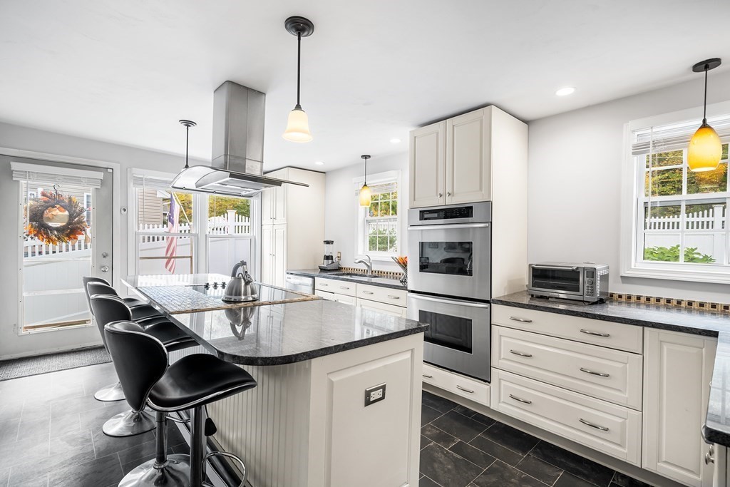 9 Tucker Lane Sutton, MA 01590 - Photo 14 of 33 a kitchen with kitchen island granite countertop a sink stainless steel appliances and dining table
