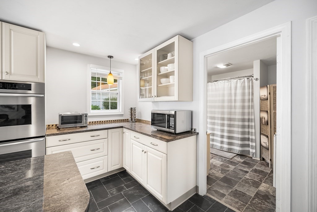 9 Tucker Lane Sutton, MA 01590 - Photo 16 of 33 a kitchen with granite countertop a sink stove and cabinets