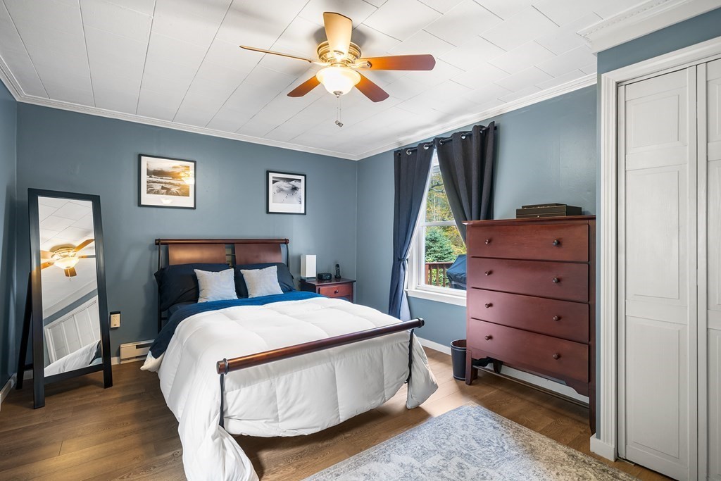 9 Tucker Lane Sutton, MA 01590 - Photo 17 of 33 a bedroom with a bed and a chandelier