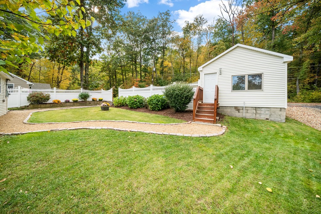 9 Tucker Lane Sutton, MA 01590 - Photo 32 of 33 a view of a house with a yard and sitting area