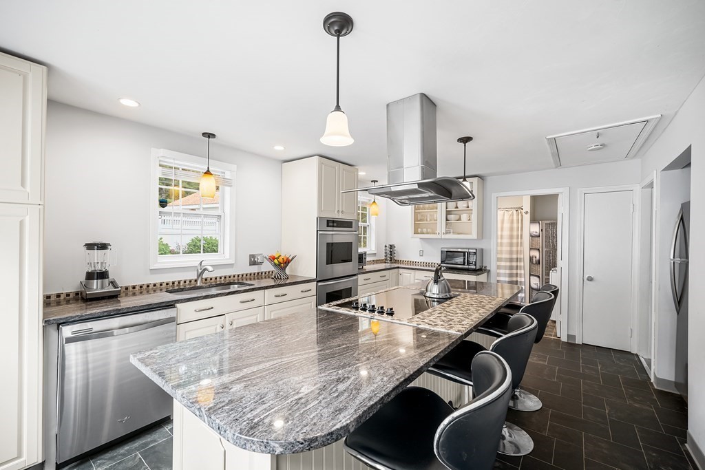 9 Tucker Lane Sutton, MA 01590 - Photo 9 of 33 a kitchen with kitchen island granite countertop a sink a center island stainless steel appliances and cabinets