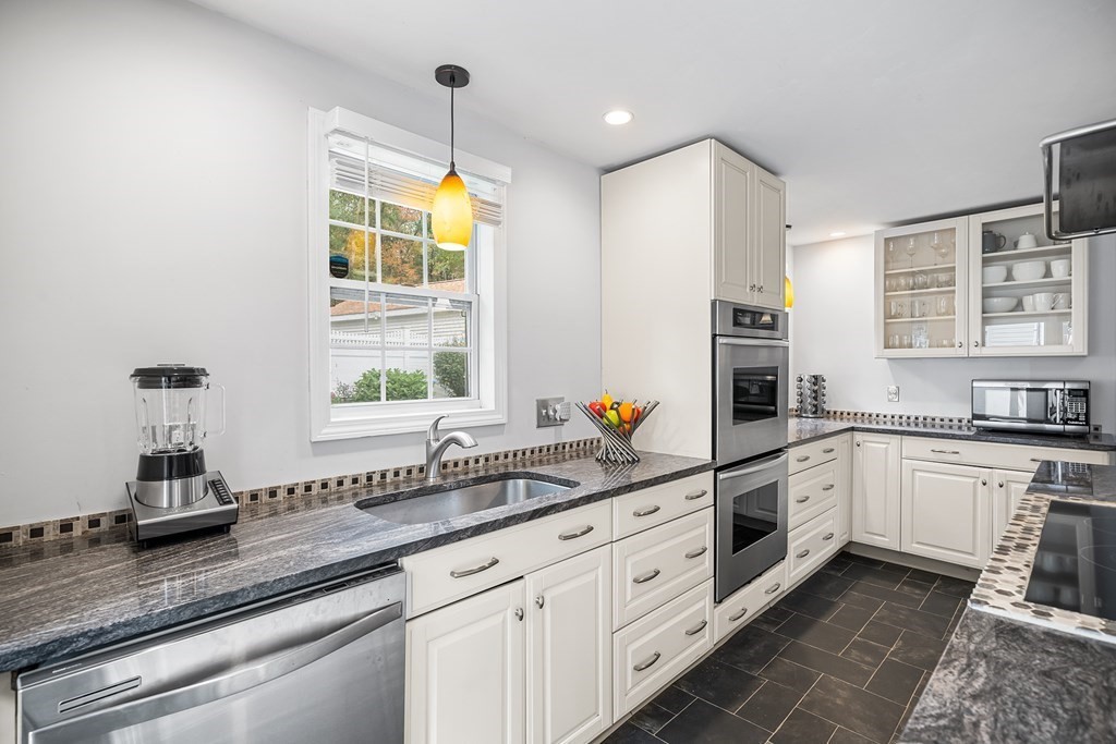 9 Tucker Lane Sutton, MA 01590 - Photo 10 of 33 a kitchen with granite countertop a sink stainless steel appliances and cabinets