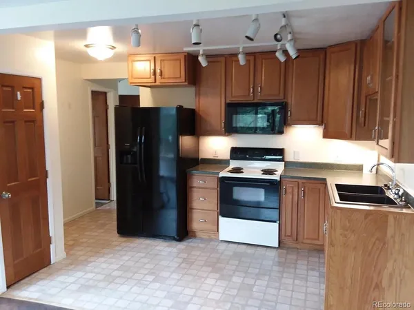 a view of a hallway with wooden floor and stairs