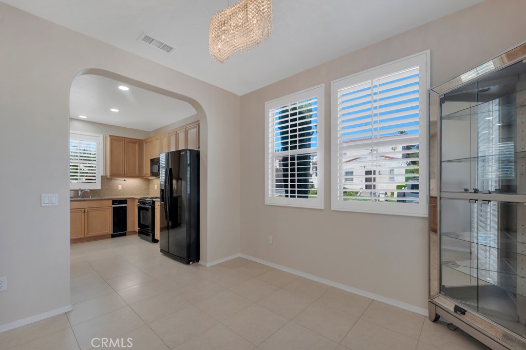 11522 Cararra Lane Porter Ranch, CA 91326 - Photo 12 of 32 a view of a kitchen with refrigerator and windows