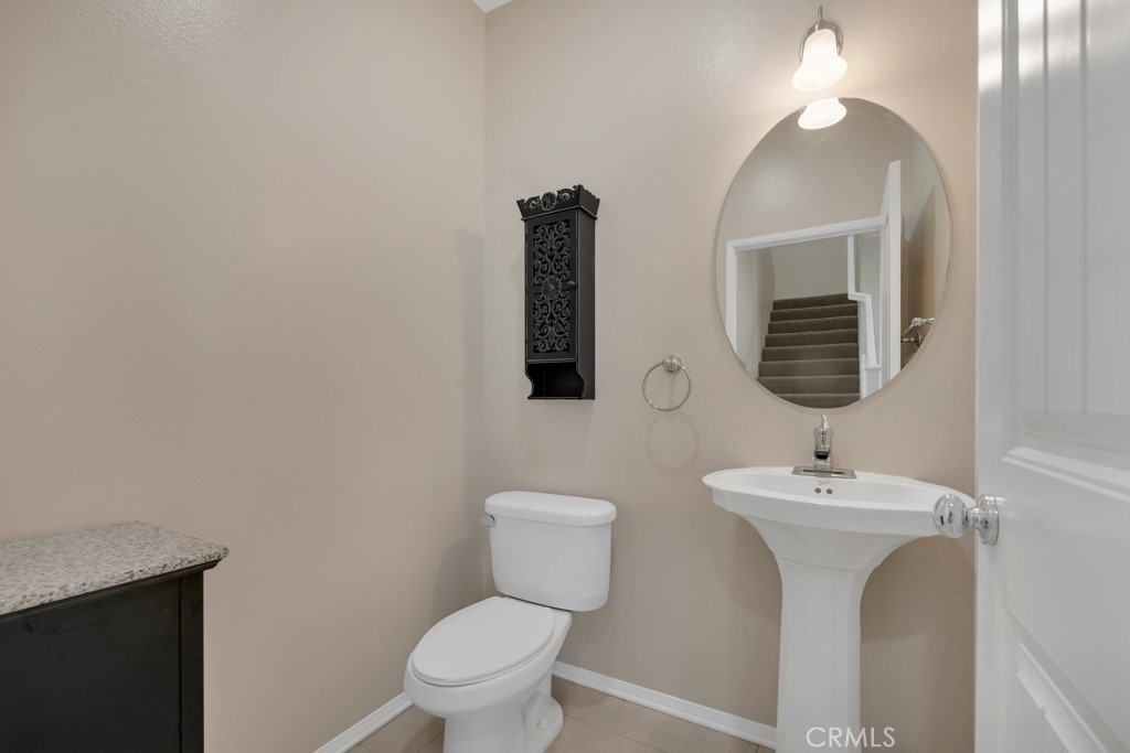 11522 Cararra Lane Porter Ranch, CA 91326 - Photo 13 of 32 a bathroom with a toilet sink and mirror
