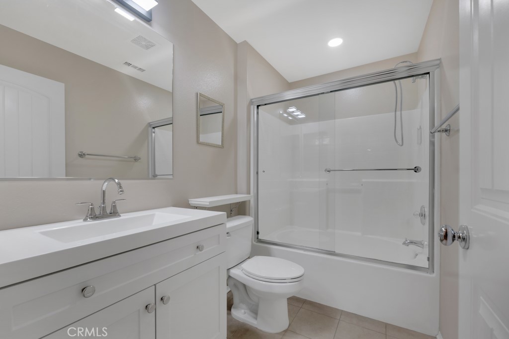 11522 Cararra Lane Porter Ranch, CA 91326 - Photo 16 of 32 a bathroom with a sink a toilet and shower