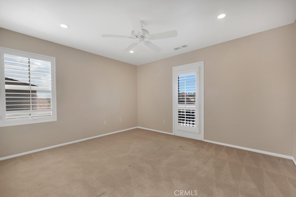 11522 Cararra Lane Porter Ranch, CA 91326 - Photo 17 of 32 an empty room with a window and a ceiling fan
