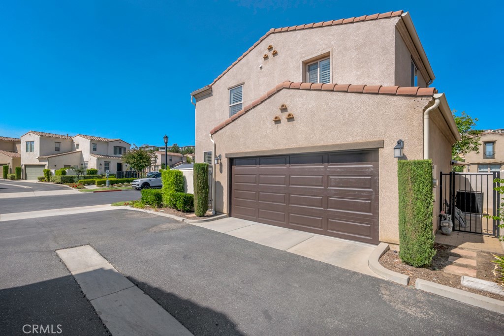 11522 Cararra Lane Porter Ranch, CA 91326 - Photo 2 of 32 a front view of a house with a yard and garage