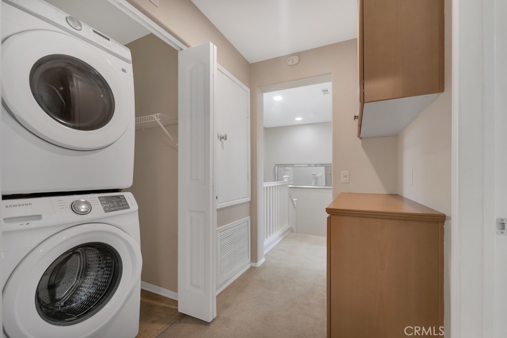 11522 Cararra Lane Porter Ranch, CA 91326 - Photo 21 of 32 a view of a hallway with washer and dryer