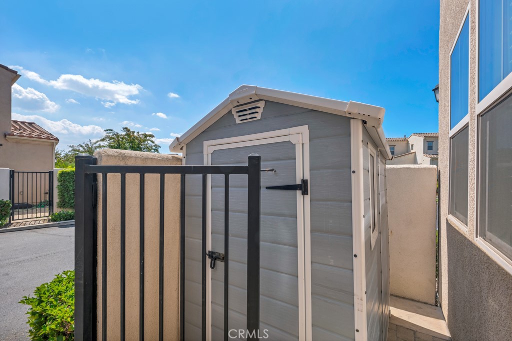 11522 Cararra Lane Porter Ranch, CA 91326 - Photo 25 of 32 a front view of a house with wooden fence