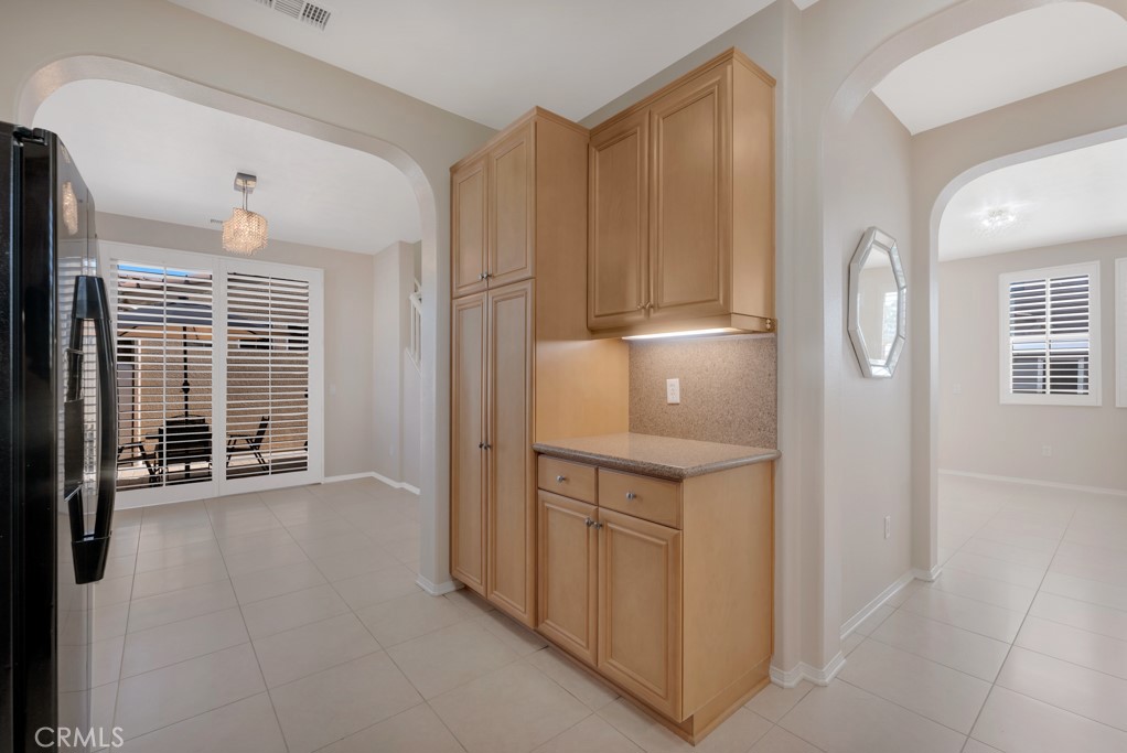 11522 Cararra Lane Porter Ranch, CA 91326 - Photo 9 of 32 a view of cabinets with wooden floor and electronic appliances