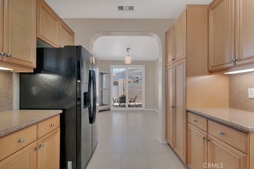 11522 Cararra Lane Porter Ranch, CA 91326 - Photo 10 of 32 a kitchen with stainless steel appliances a refrigerator and a stove top oven