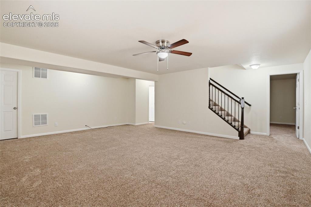 7806 Dutch Loop Colorado Springs, CO 80925 - Photo 25 of 41 a view of an empty room with a ceiling fan