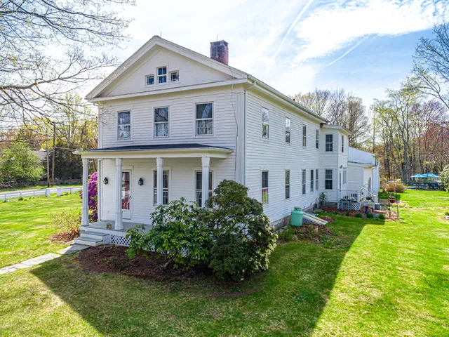 a front view of house with yard and green space
