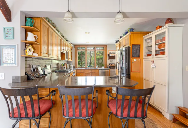 a dining room with furniture a chandelier and window