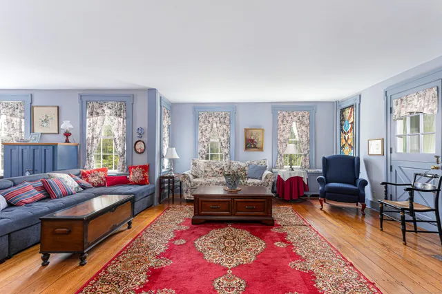 a living room with furniture rug and window