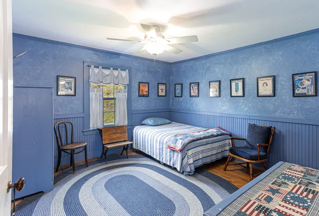 a bedroom with a bed and a lounge chair