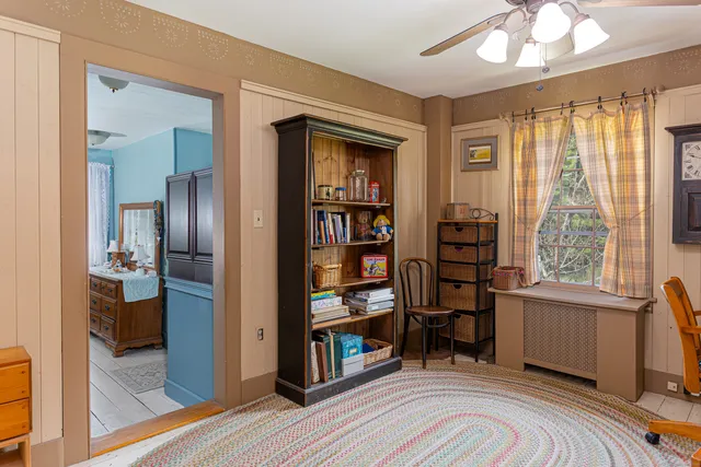 a view of a livingroom with workspace and a window