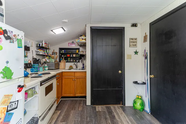a kitchen with stainless steel appliances granite countertop a refrigerator and a stove top oven