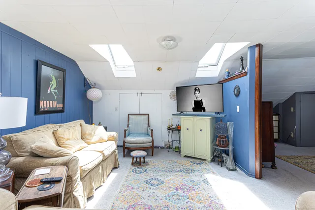 a living room with furniture and a dresser