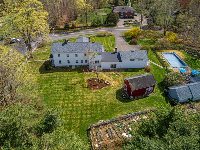 an aerial view of a house with yard swimming pool and outdoor seating