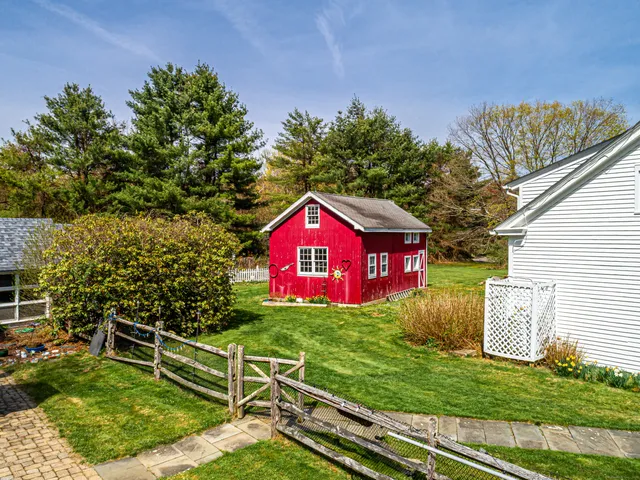a sign that is sitting on a wooden fence