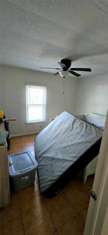 14820 County Road 48 Astatula, FL 34705 - Photo 10 of 12 a bedroom with a bed and window