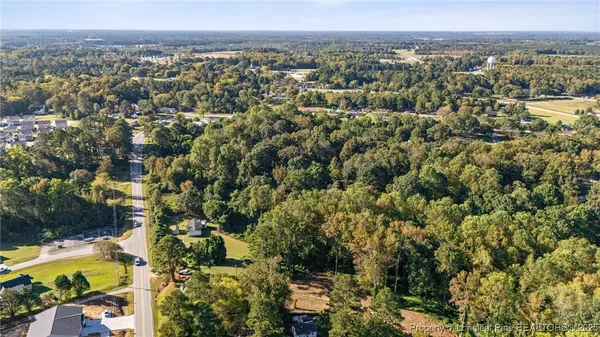 an aerial view of a residential houses with city view