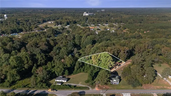 an aerial view of a residential house with a yard