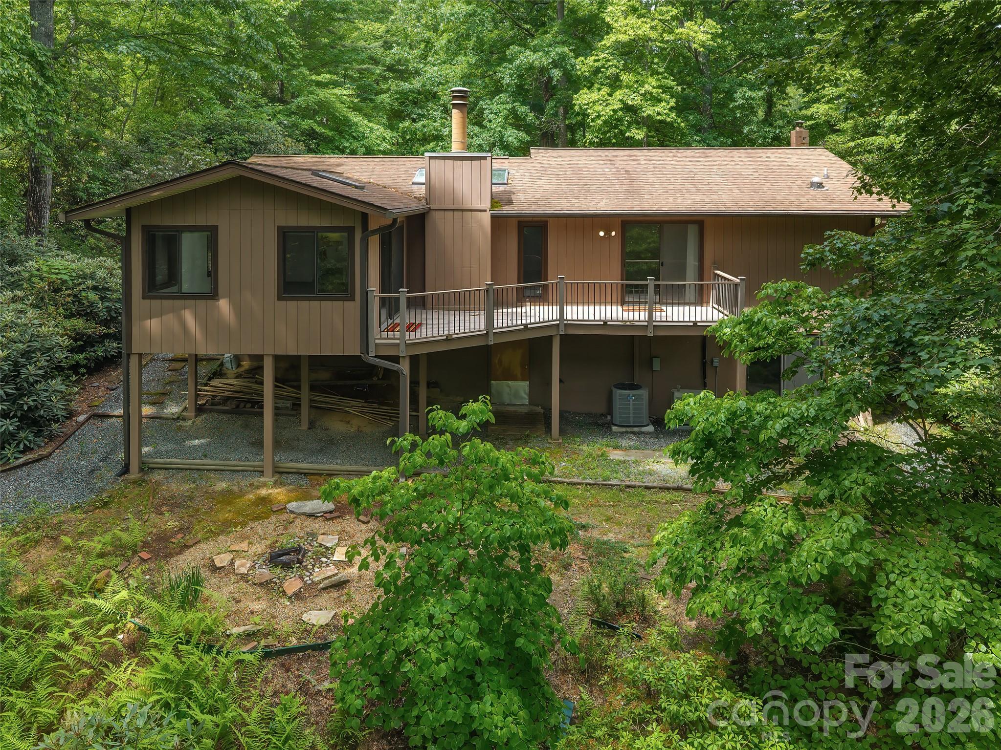 32 Honey Suckle Ridge Road Pisgah Forest, NC 28768 - Photo 3 of 35 a front view of a house with garden