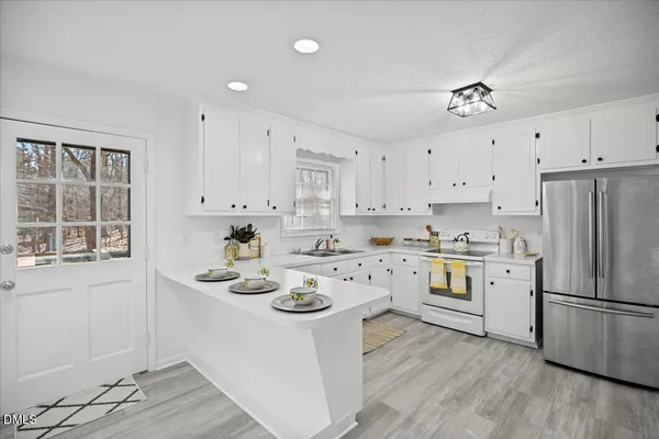 a kitchen with cabinets a sink and appliances