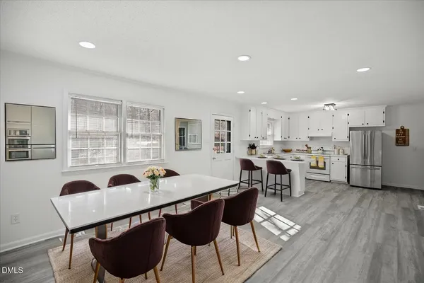 a kitchen with stainless steel appliances lots of white appliances and cabinets