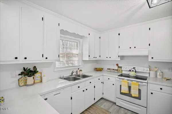 a view of kitchen with windows and refrigerator
