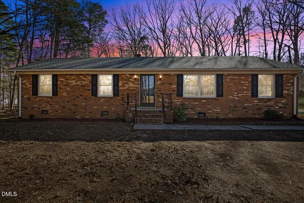 a swimming pool with outdoor seating and yard