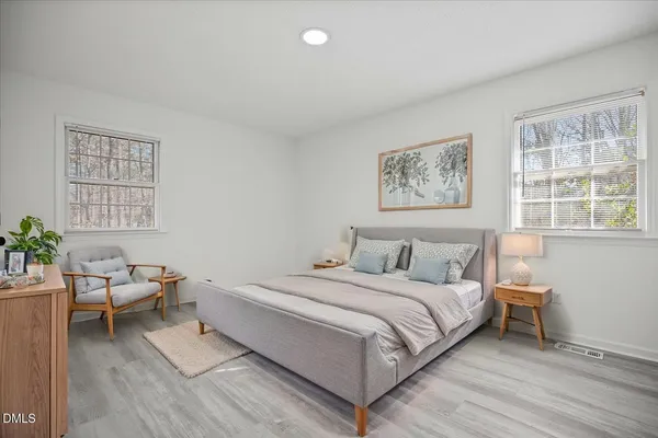 a view of room with wooden floor and white walls