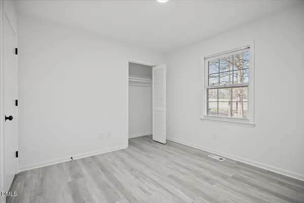 a bedroom with bed and window