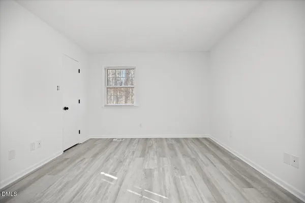 a bedroom with a bed and a desk