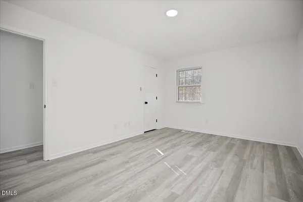 a bathroom with a granite countertop sink mirror and toilet