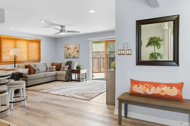 a bedroom with a bed and a large mirror with a chandelier