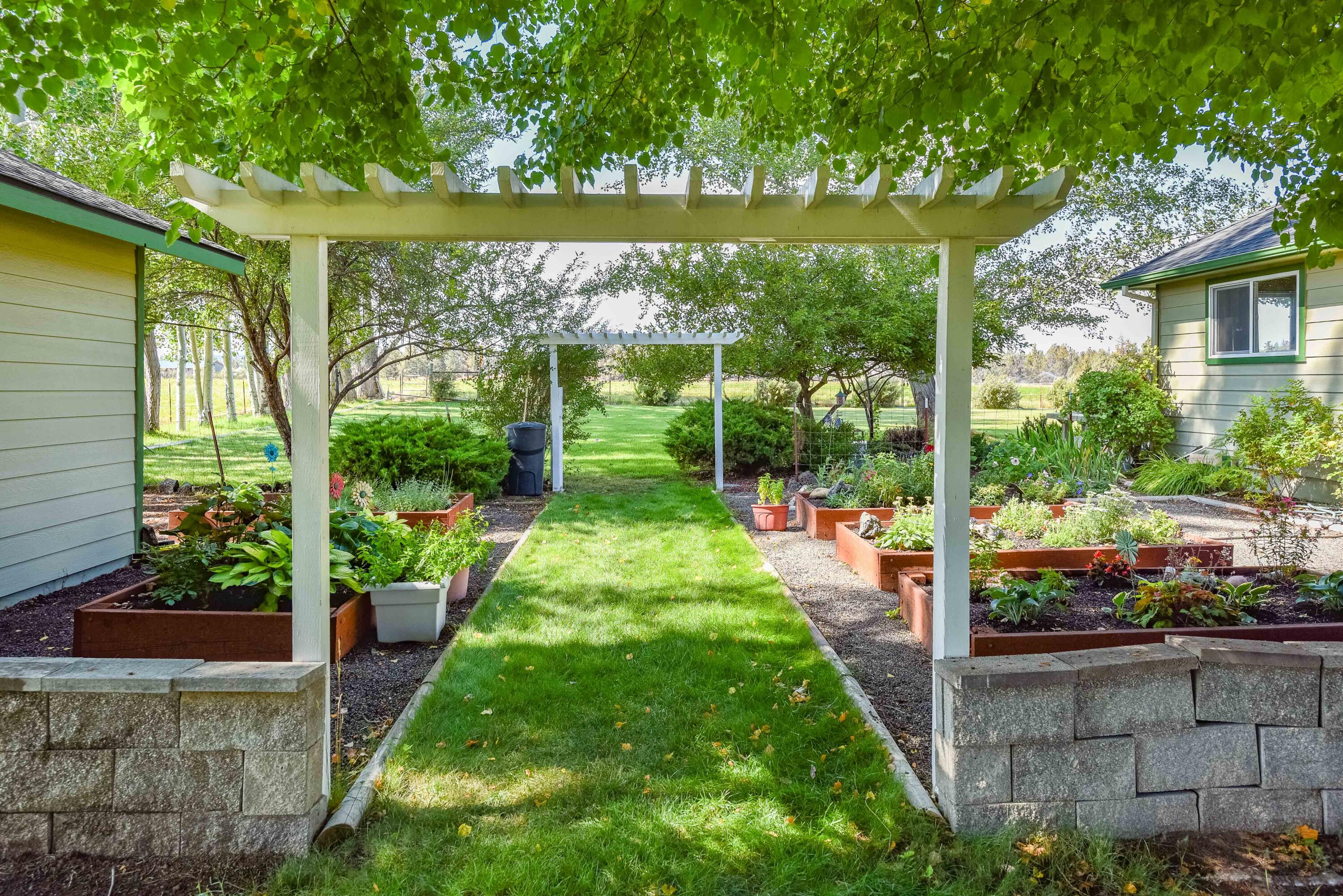 63475 Cricketwood Road Bend, OR 97701 - Photo 24 of 64 a view of a backyard with garden