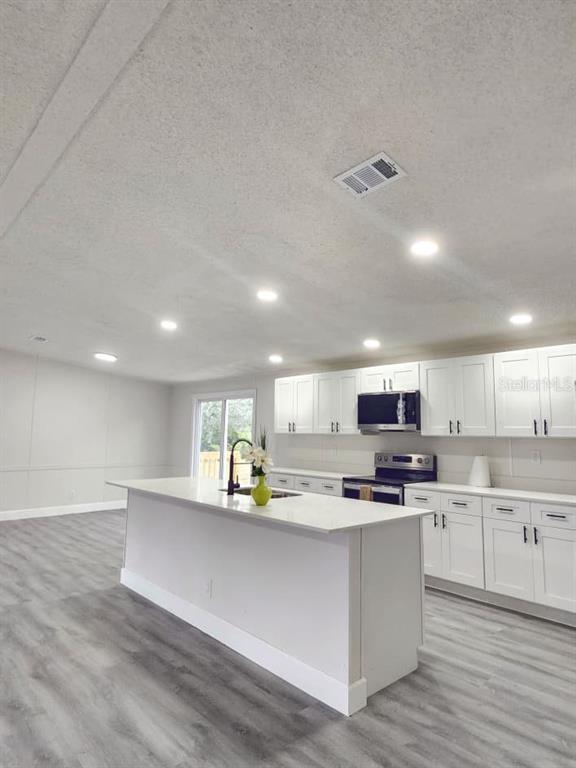 5641 South Butan Point Homosassa, FL 34446 - Photo 4 of 14 a kitchen with kitchen island counter top space cabinets and appliances